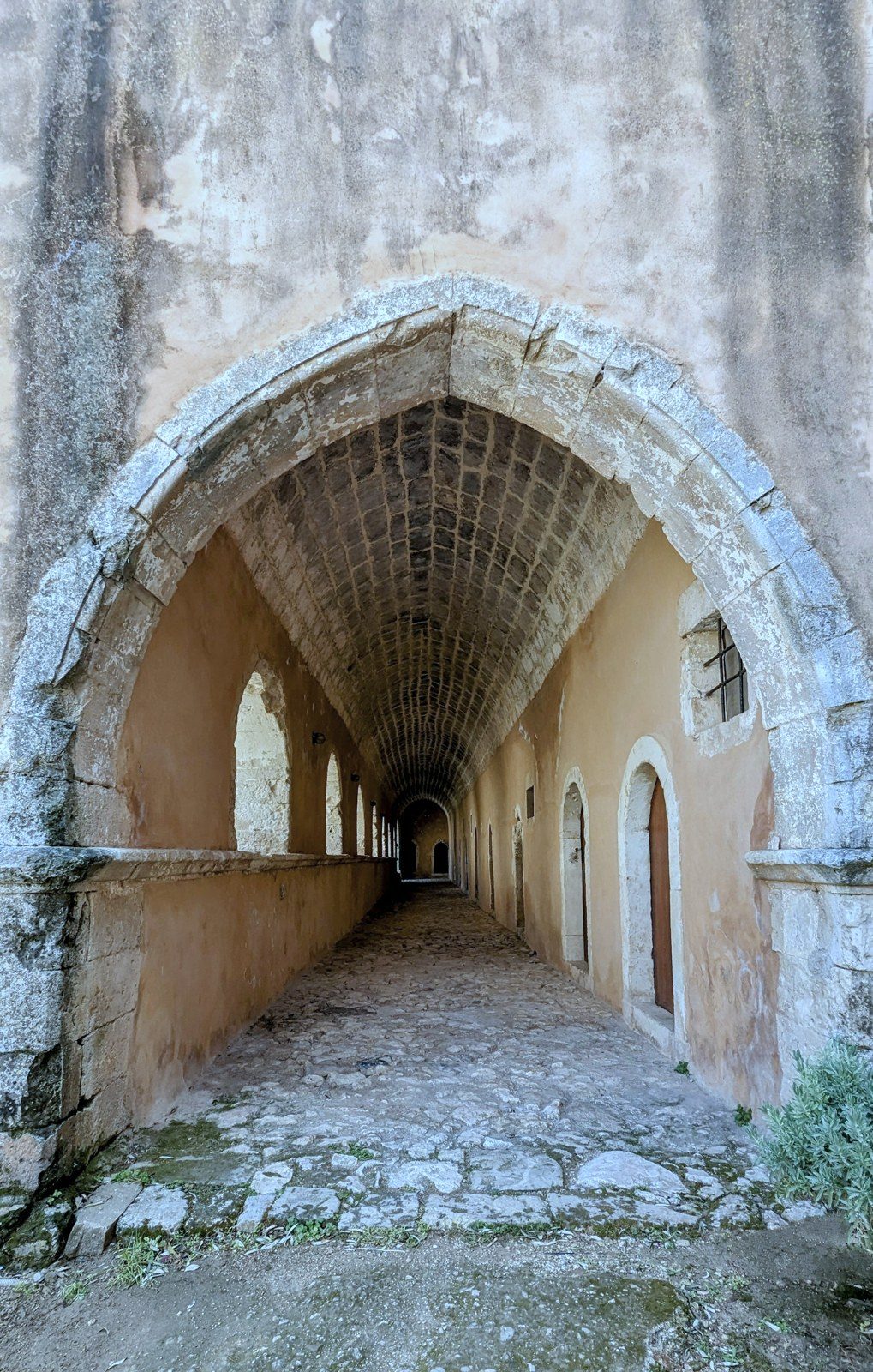 A long stone archway receding into the distance